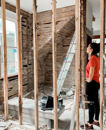 Lady standing in a house that is getting renovated