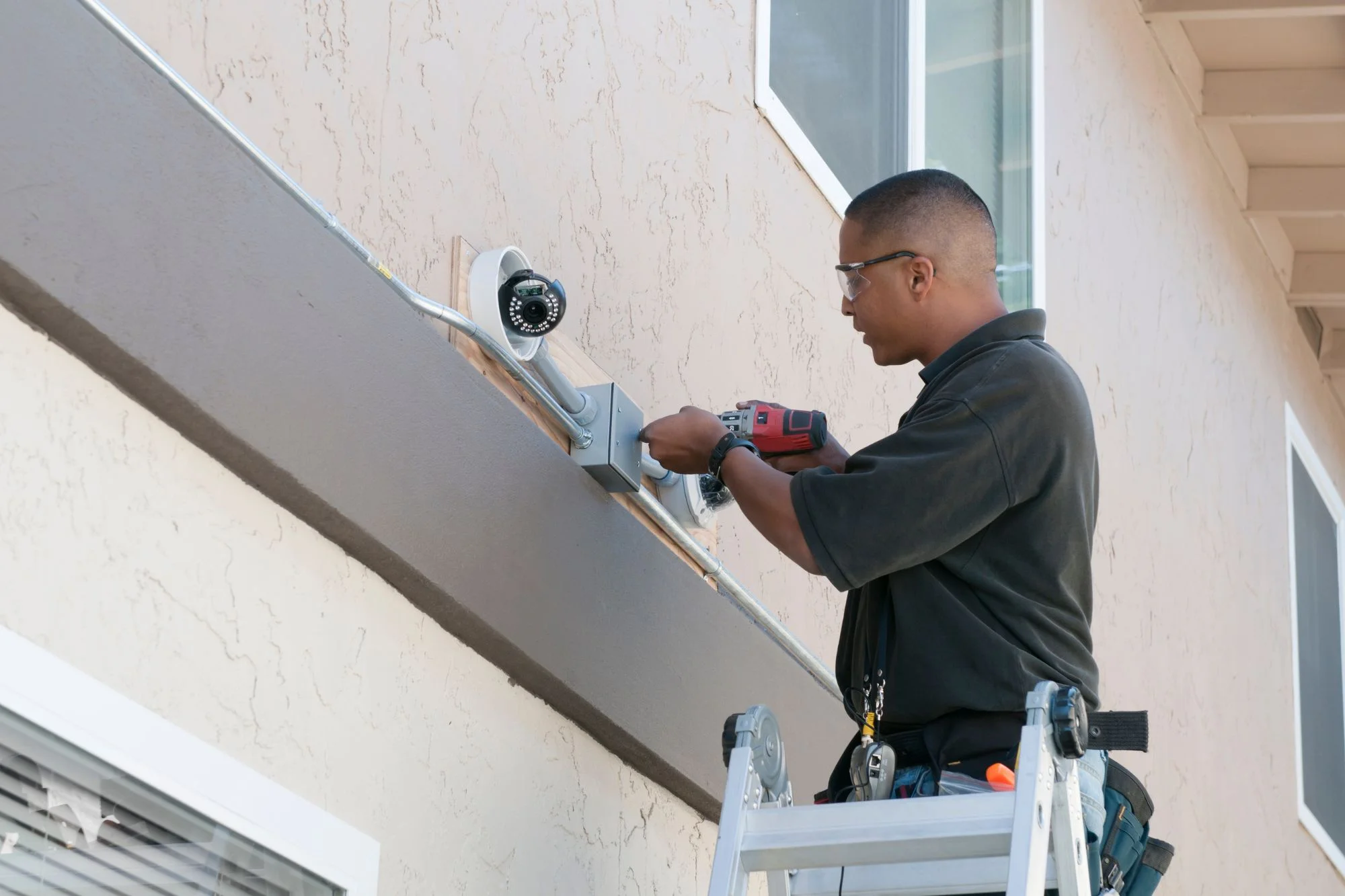 Man installing home security cameras