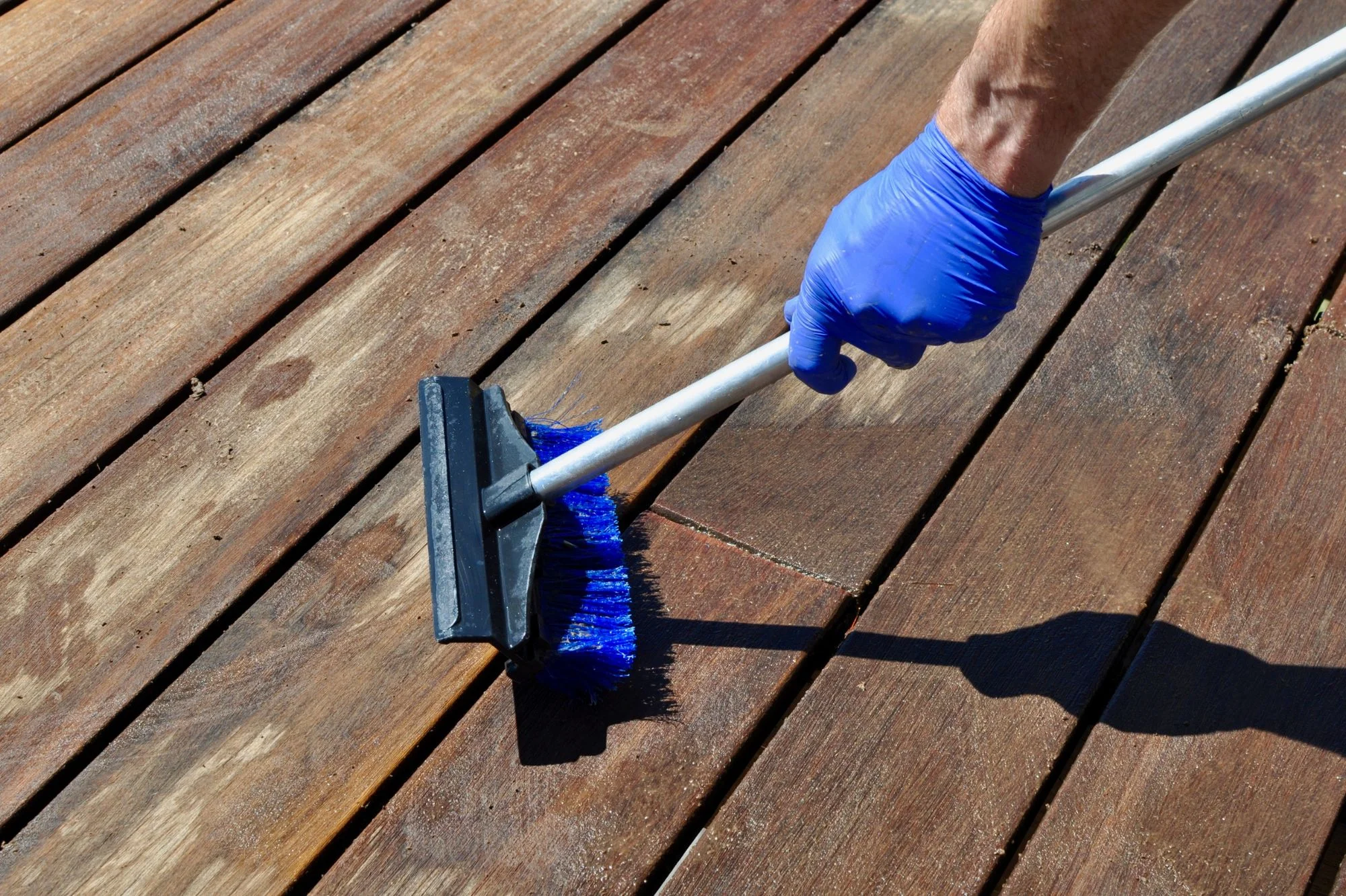 Person cleaning a deck