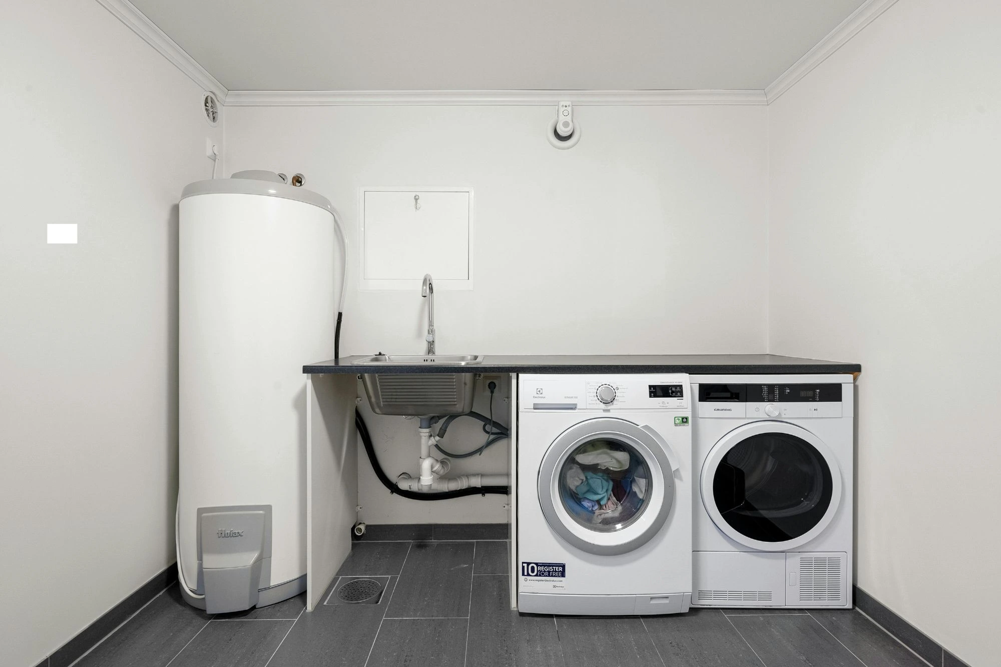 Hot water system installed inside of a laundry